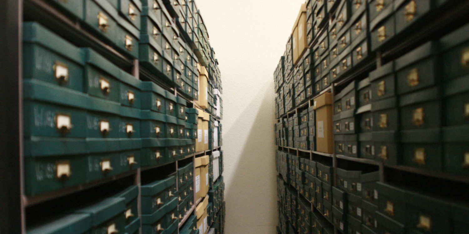 Stacks of archival boxes on shelves in the vault at the Mennonite Heritage Archives