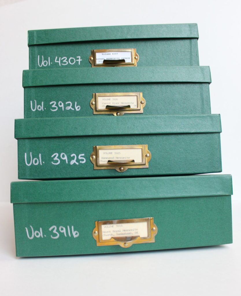 Stack of four green archival boxes