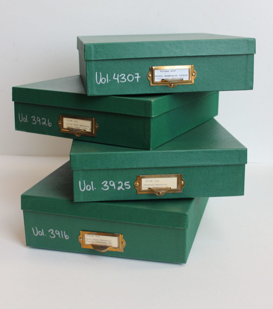 Stack of four green archival boxes